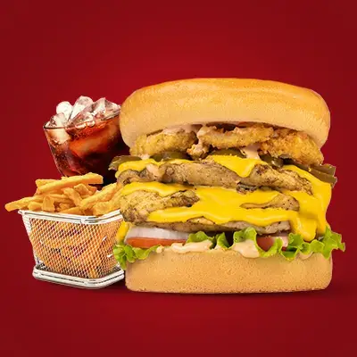 a large burger with fries and a drink